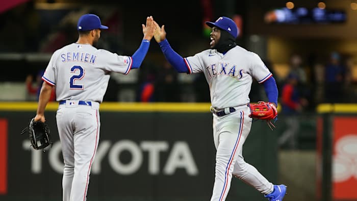 Apr 21, 2022; Seattle, Washington, USA; Texas Rangers second baseman Marcus Semien (2) greets right fielder Adolis Garcia (53) as they celebrate their 8-6 win over the Seattle Mariners at T-Mobile Park. Mandatory Credit: Lindsey Wasson-USA TODAY Sports